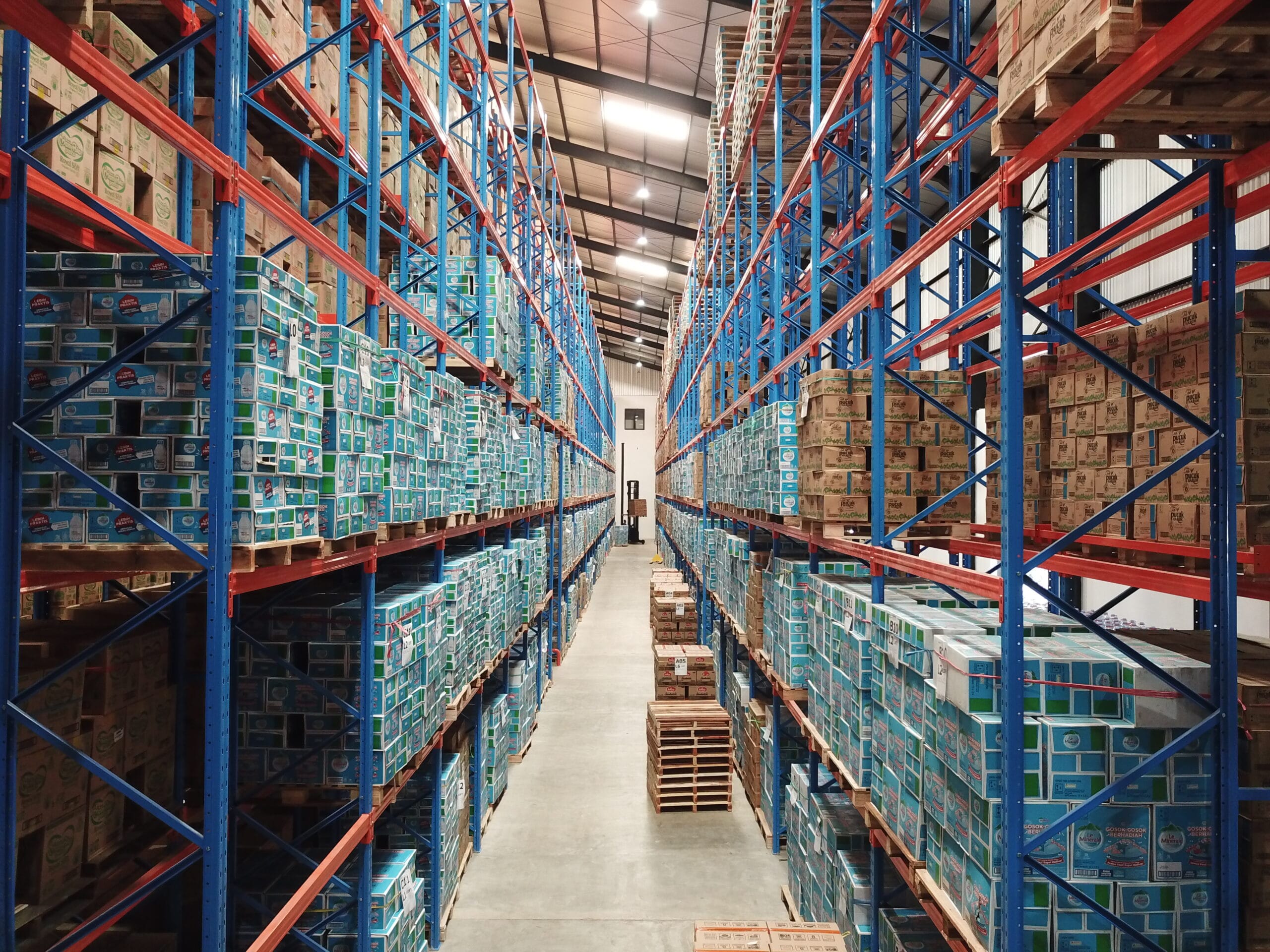 Interior of the DSPX warehouse in Surabaya featuring high-bay storage racks, palletized inventory, and organized logistics operations.