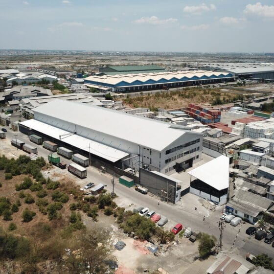 Aerial drone view of the exterior of the DSPX logistics warehouse facility in Surabaya, Indonesia.